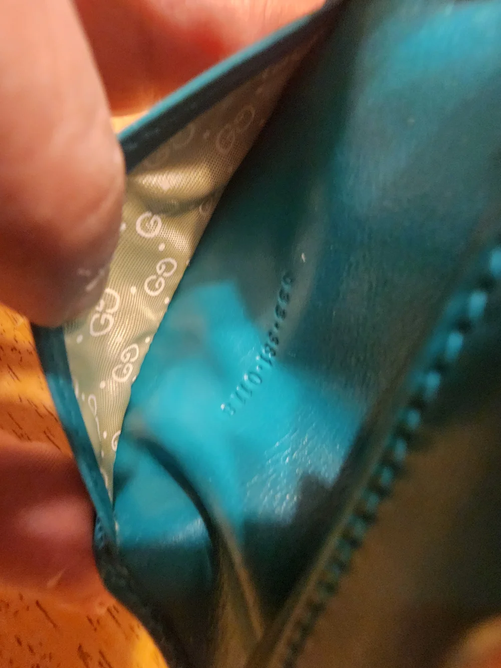 vintage Gucci teal leather key case featuring a distinctive cabochon stone